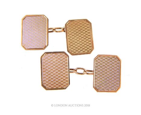 A pair of 9 ct yellow gold, engine turned, cufflinks each composed of two rectangular panels, Panel: 11 x 15 mm, Gross weight
