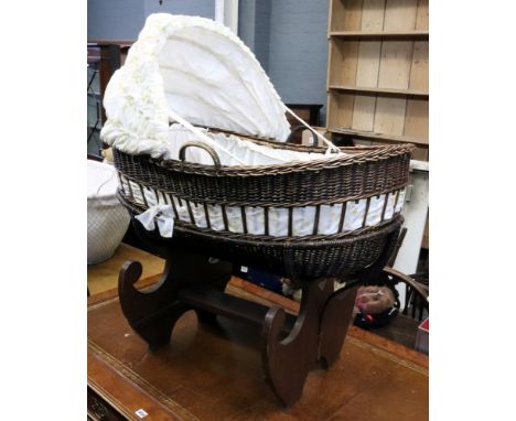 A Dutch child's oval wicker cradle with hood, first half 20th century, on wicker frame oak stand, with shaped end standards, 
