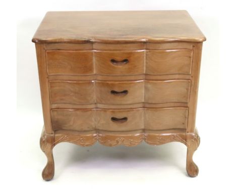 A hardwood chest, in mid 18th century style, first half 20th century, of shaped outline, fitted with three drawers, leafy scr