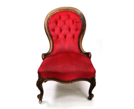 A Victorian walnut frame nursing chair, circa 1860, the button down upholstered spoon shape back and stuff over seat, in red,