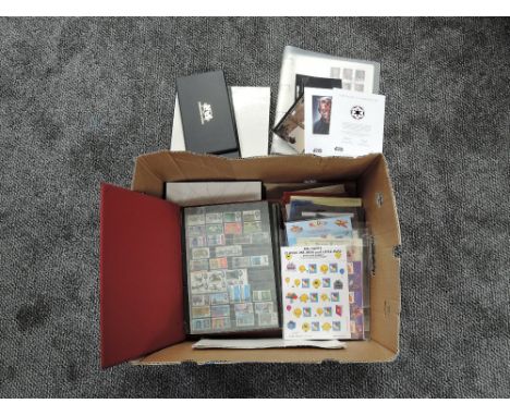 A box containing 2002 &amp; 2007 Royal Mail Year Books, album of GB mint Stamps, Royal Mail Post Cards, Lest We Forget/Celebr