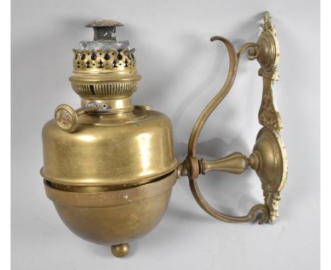 A Vintage Wall Mounting Brass Oil Lamp and Holder, 38cms High 