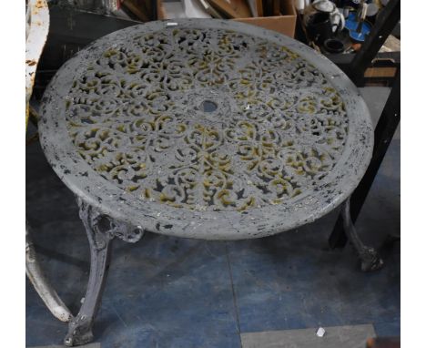 A Cast Metal Cylindrical Patio Coffee Table with Pierced Top Supported on Tripod Legs of Scrolled Form Culminating in Dolphin