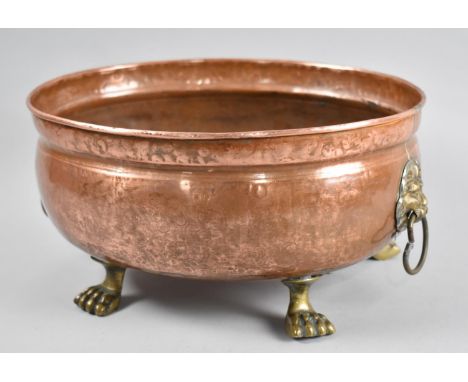 An Oval Copper Planter with Brass Lion Mask Ring Handles and Four Brass Claw Feet, 30cms Long 