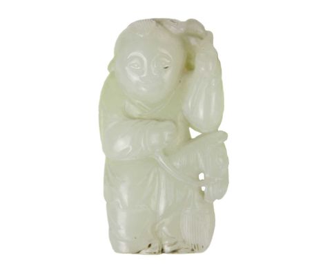 A Chinese celadon jade figure of a boy with hobby horse, Qing Dynasty, 19th century.  With left hand holding his hat, height 