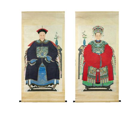 A large pair of Chinese ancestor portrait scroll paintings, late 19th/early 20th century. The seated male figure wearing a bl