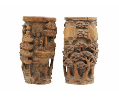 A pair of Chinese carved bamboo brush pots, Qing Dynasty, 19th century. Carved with figures, pagodas and trees, height 12.5cm