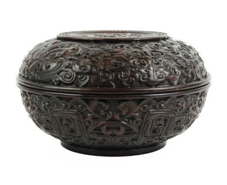 A Chinese hardwood sweetmeat box and cover, circa 1900. Carved with foliage and cloud scrolls, height 12cm, diameter 20cmligh