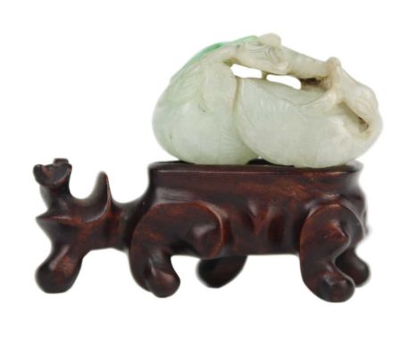 A Chinese carved jade goose turned to grasp lotus, Qing Dynasty, 19th century. Height 2.7cm, length 5cm, depth 1.5cm, with as
