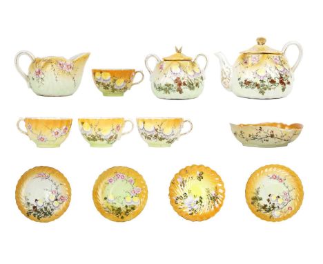 A Japanese porcelain tea service, early 20th century. Floral and gilt decorated, comprising a teapot, sugar bowl, cream jug, 