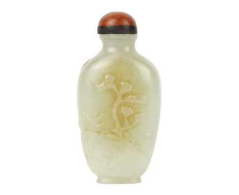 A Chinese jade snuff bottle, Qing Dynasty, 19th century. Decorated in relief with a tree in a landscape, height 7.5cm, width 