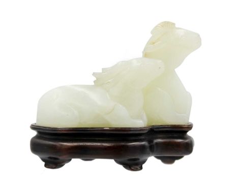 A Chinese carved celadon jade group of deers, Qing Dynasty, 19th century. Height 4.8cm, width 7cm, depth 3.5cm, with a fitted