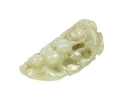 A Chinese carved jade pendant, Qing Dynasty, 18th/19th century. Probably depicting a rat amongst grapes, length 5.3cm, width 