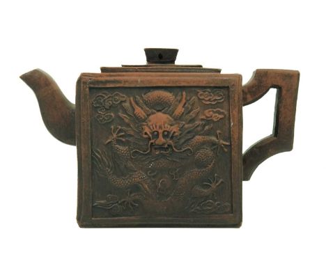 A Chinese Yixing teapot, 20th century. Decorated with stylised dragons, character marks to finial, seal mark to base, height 