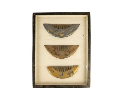 A collection of three Japanese gold lacquer combs, Meiji period.  Two decorated with butterflies, the third with implements a