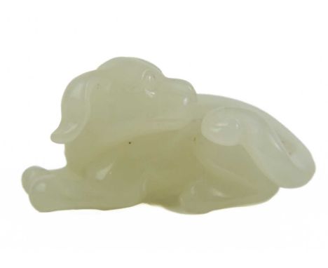 A Chinese jade model of a reclining dog, late Qing Dynasty. Height 2cm, width 4cm, depth 2cm.
