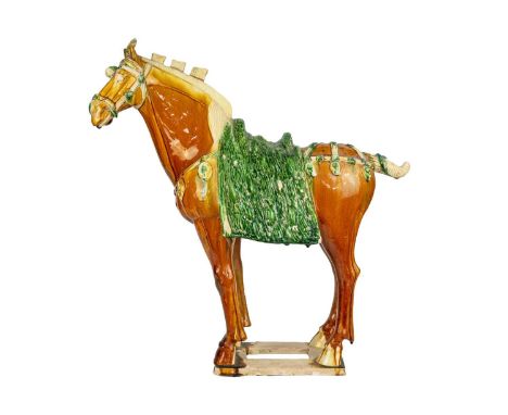 A large Chinese Tang style sancai model of a horse. Height 58cm, length 54cm, depth 22cm.The model is not free of chips or cr