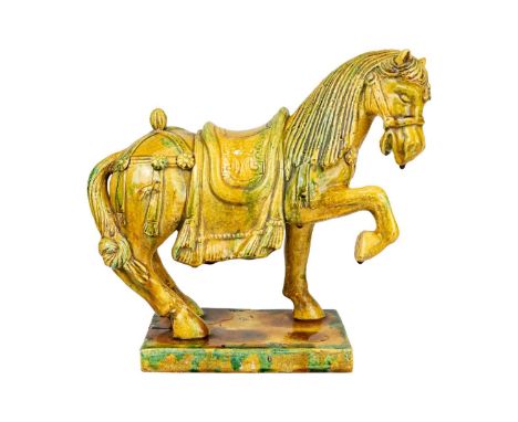 A Chinese Tang style Sancai glazed model of a horse. Height 31cm, width 34cm, depth 15cm.