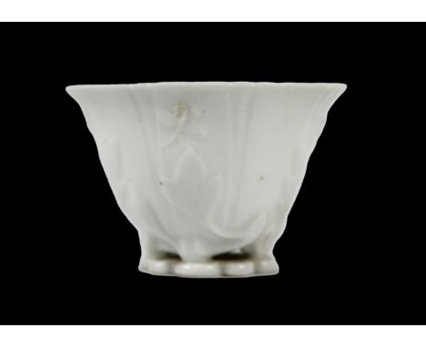 A Chinese blanc de chine libation cup, Qing Dynasty, 18th century. With leafy floral decoration, height 4cm, width 6.5cm, dep