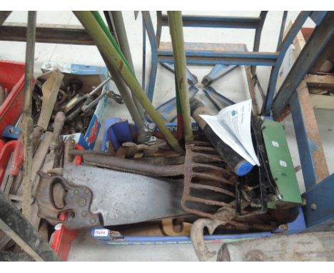 A selection of gardening tools including paper brick maker