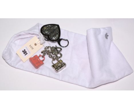 Three Mulberry key chains, two of bag pattern, one in silver, the other in pink enamel; one of heart design; with white Mulbe