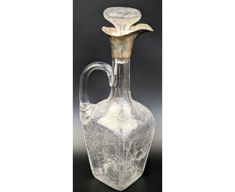 An Edwardian silver and glass wine carafe by William Comyns, the rectangular glass body with etched floral decor, fluted neck