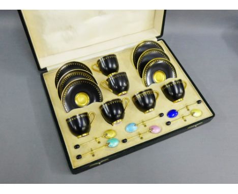 Royal Worcester black glazed demi tasse cups and saucers, together with a set of six gilt metal and harlequin enamelled coffe