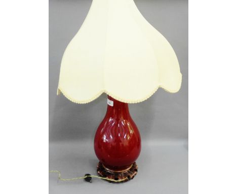 Sang de boeuf style glazed pottery table lamp on hardwood base, complete with a shade, size excluding fitting 45cm 