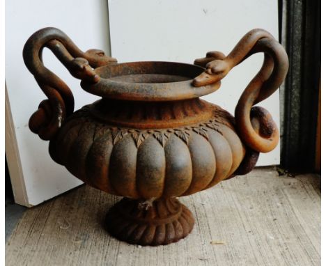 Cast iron planter of circular form with serpent handles, 56cm x 70cm 