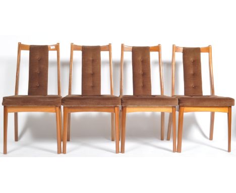 A set of four retro vintage 20th Century Danish influence teak wood dining chairs having shaped top rails with button cushion