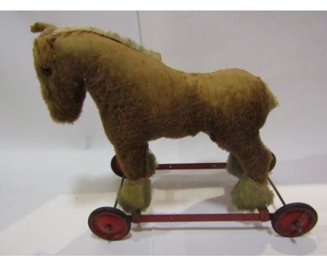 A 1950s Chiltern straw filled push along horse
