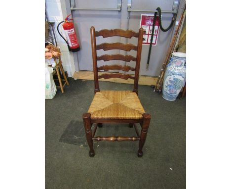 A set of eight (6+2) oak ladder back dining chairs the rush seats over turned legs united by stretchers 