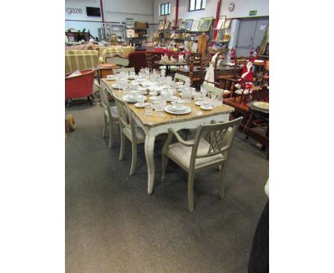 A rustic French oak shaped top dining table on painted base, with light/distressed top and six (4+2) matching dining chairs w