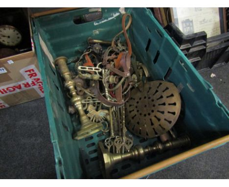A box of mixed brassware fire tools, candlesticks, spurs, etc