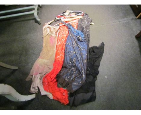 Four various evening dresses: black decorated with sequins, red lace style overlay, navy with matt gold bugle beads and oyste