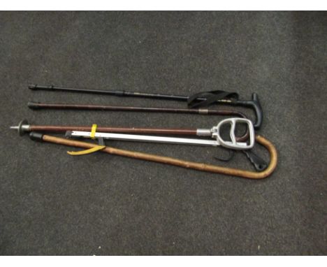 A shooting stick and various walking sticks