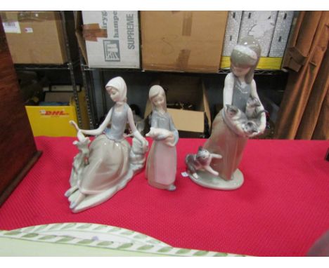 Three Lladro figurines: girl with cat and kittens, girl with piglet and a girl with a dove