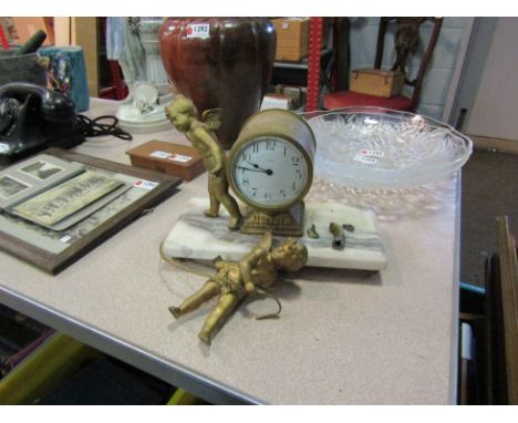 A 19th Century ormolu mantel clock with cherubic detail, enamelled Arabic dial, on marble plinth base. Cherub a/f