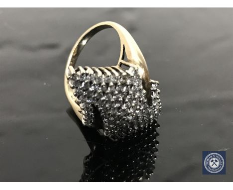 A diamond cluster ring, upon a yellow gold shank, finger size P/Q