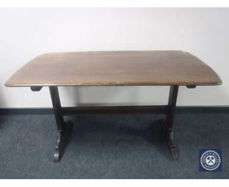 An Ercol elm refectory dining table 