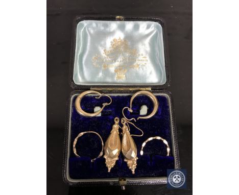 Three pairs of gold earrings