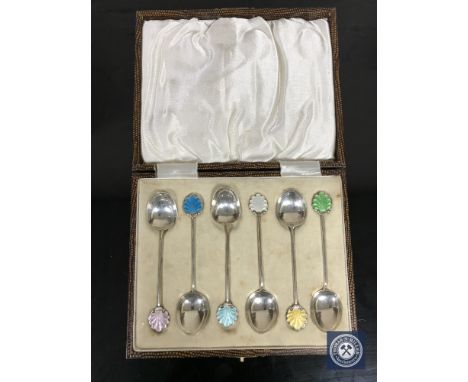 A set of six cased silver and enamel coffee spoons