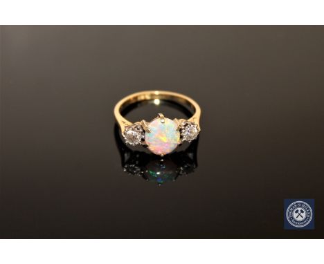 An 18ct gold opal and diamond three-stone ring, size M CONDITION REPORT: The ring is in good condition. It is stamped 18ct bu