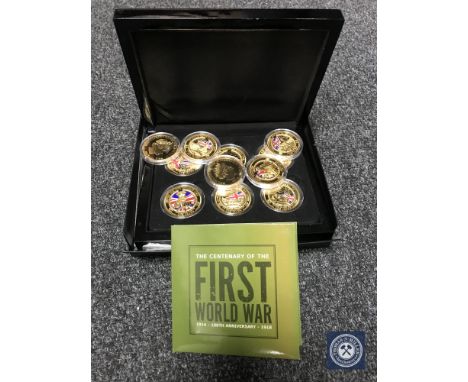 Eleven gold-plated and enamelled coins commemorating the Centenary of the First World War, cased, together with a 2014 £5 coi