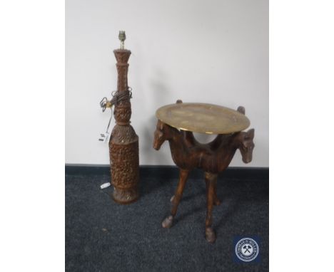 A carved hardwood table lamp with a brass topped occasional table 