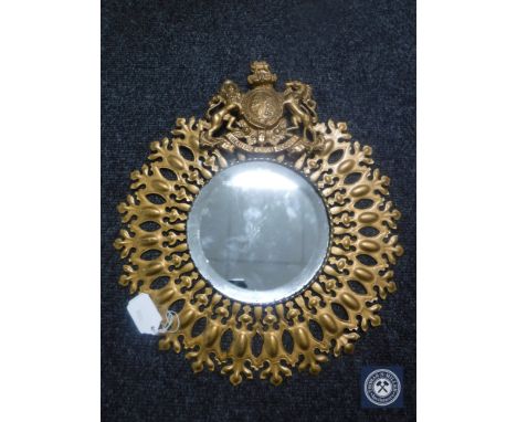A metal framed mirror bearing The Royal Coat of Arms 