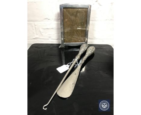 A sterling silver Art Deco photo frame, a shoe horn and button hook 