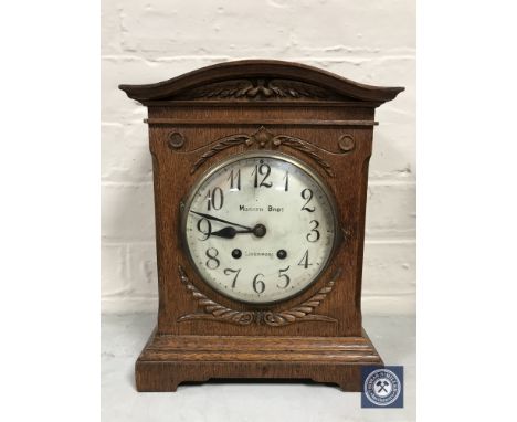 An oak cased bracket clock retailed by Morath Brothers of Liverpool, with pendulum