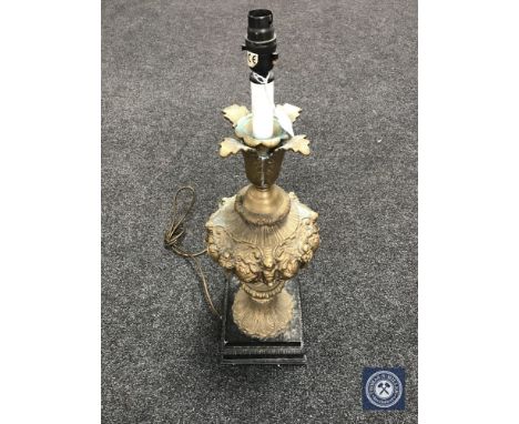 An antique gilded table lamp on metal base 