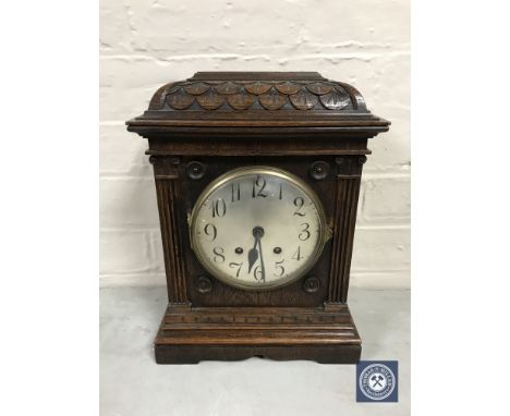 A carved oak cased Lenzkirch bracket clock with silvered dial, pendulum and key